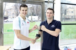 Oxford captain Dominic McLoughlin and Cambridge captain collect the men's trophy